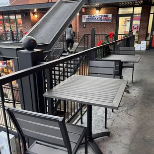 tables and chairs on a sidewalk