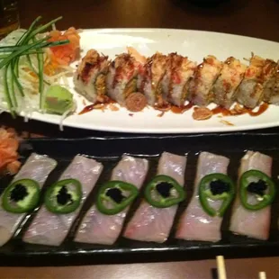 Cajun roll and yellowtail sitting in ponzu sauce topped with jalapeño slices and black caviar.