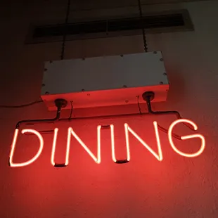 a neon sign that reads dining