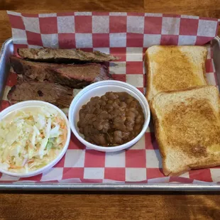 Rubbin Butts brisket dinner with coleslaw, baked beans and Texas toast.
