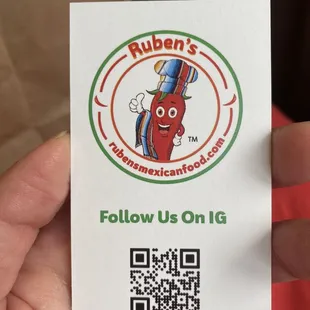 a hand holding a business card