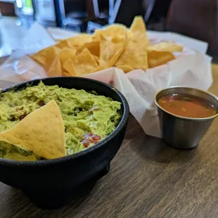 a bowl of guacamole and chips