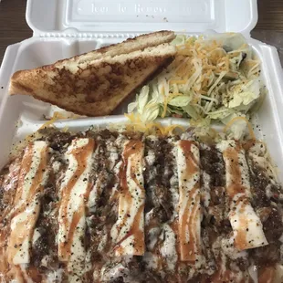 Baked potato with brisket, salad and toast.
