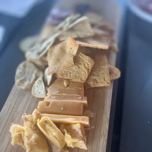 cheese and crackers on a cutting board