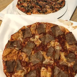 Sausage pizza in front. Mushroom in back.