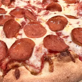 Pizza with Cheese + 1 Topping (Pepperoni). Medium (ten slices). House made sauce &amp; dough. Thick, stringy mozzarella cheese.