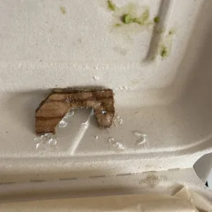 Ordered  Loaded Nachos with steak and bit on this piece of cardboard. I rinsed it off to see what it was.