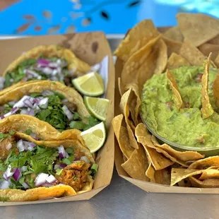 Carne asada  and chorizo with a side of guac and chips .