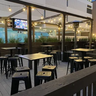 a patio with tables and chairs