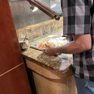 Guy loading this breaded shrimp