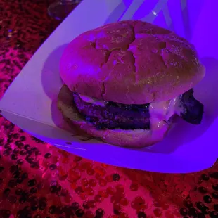 a hamburger in a paper container