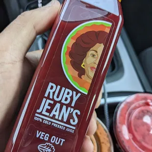 a hand holding a bottle of vegg out