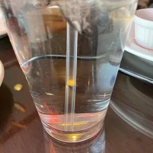 a glass of water with a straw