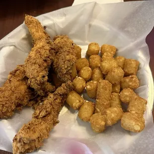 Hand breaded chicken tenders and tots