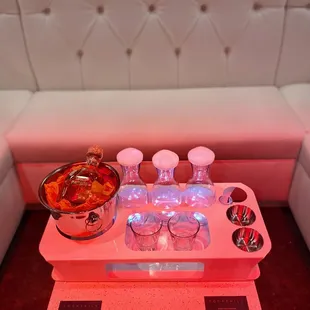 a tray with glasses and a bowl of fruit