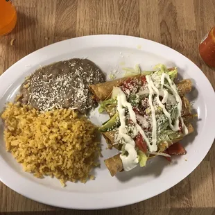 a plate of mexican food and a drink