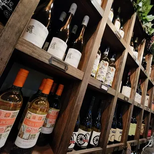 a shelf of wine bottles