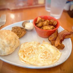 Breakfast Potatoes, over-easy eggs, bacon, biscuit
