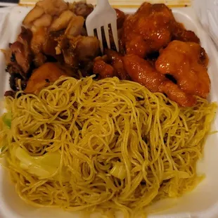 a takeout container with noodles and chicken