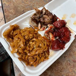 a plate of noodles, meat, and sauce