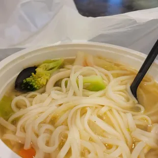 a bowl of noodles and broccoli
