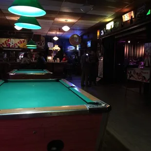 Two pool tables in the main bar area.
