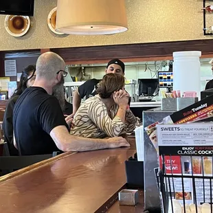 Store manager and staff at the bar with customers in the room.  Close this house and sell to a company that wants customers.