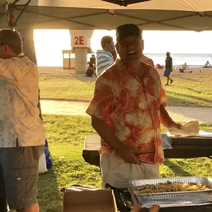 Owner Rick Nakashima serving dinner to the participates of the First Annual Polynesian Bowl