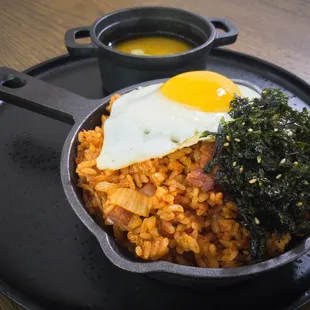 a plate of food with rice, broccoli and an egg