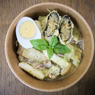 a bowl of pasta with a boiled egg