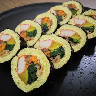 a plate of sushi rolls on a table