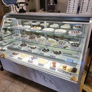 a display case with a variety of desserts