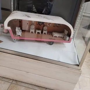 a doll house in a glass case