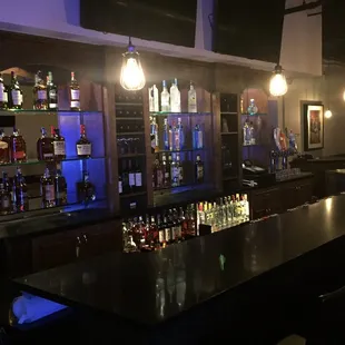 bar with liquor bottles on shelves