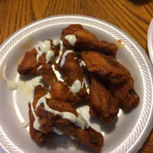 Anyway lemon pepper hot wings on my buddies plate drizzled in a little ranch