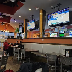 people sitting at tables in a sports restaurant