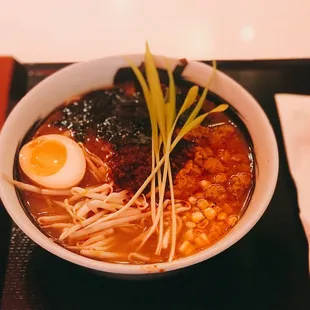 Miso LIT Ramen with Spicy Miso Broth, Soy Egg, Ground Pork, Grilled Corn, Shaved Nori, Bean Sprouts, and Ruckus Paste.