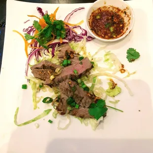 Crying Tiger *: Thai-style grilled steak with chili &amp; herb dipping sauce. $12.