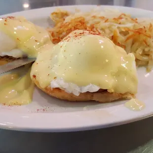 Eggs benedict with hash browns.