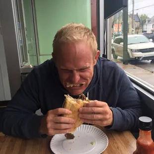 My brother digging in to a Mushroom Cheesesteak like it's his last!
