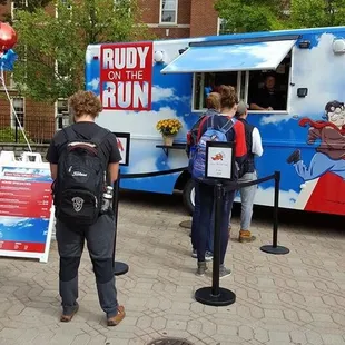people standing in front of a food truck