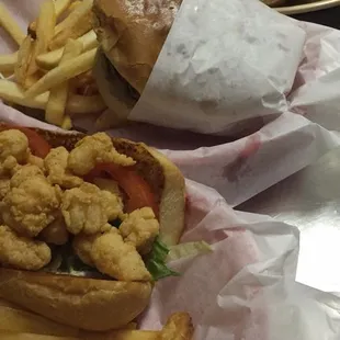 A shrimp Po&apos;Boy, CheeseBurger and Oyster Po&apos;Boy freshly made for our customers.. #RudyRoosSeafood