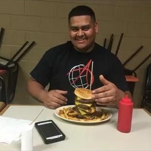 A custom made burger for the little cousin and met his expectations! #6MeatsWithBaconAndCheeseBetweenEveryPatty #3LbsOfBeef #1LbOfBacon
