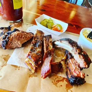 From left to right: Brisket, Pork Ribs, Baby Back Ribs, and potato salad.