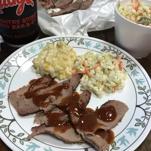 Lean brisket with original sauce and creamed corn and slaw sides.