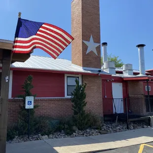 shows a flag flying in front of the building