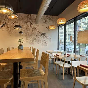 a dining area with wooden tables and chairs