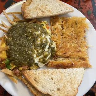 Chilaquiles with eggs and chorizo on top, toast and hash brown