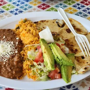 Flour quezadilla with delicious beans, rice, and a mini Salad.