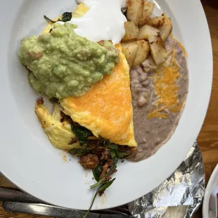 Chorizo scramble open, parentheses really more of an omelette) with refried beans, home fries, and corn tortillas